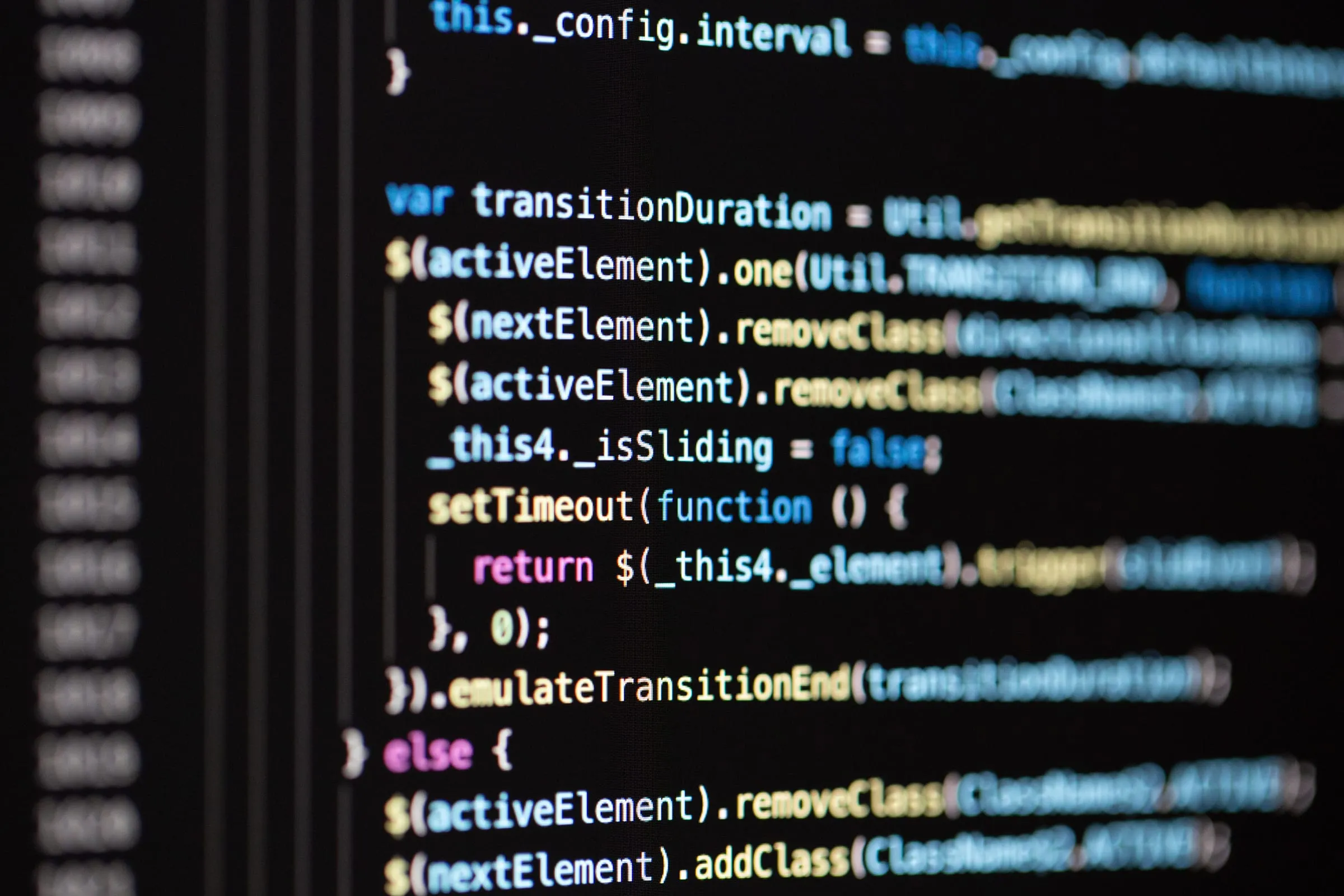 Close-up of colourful source code on a dark editor screen
