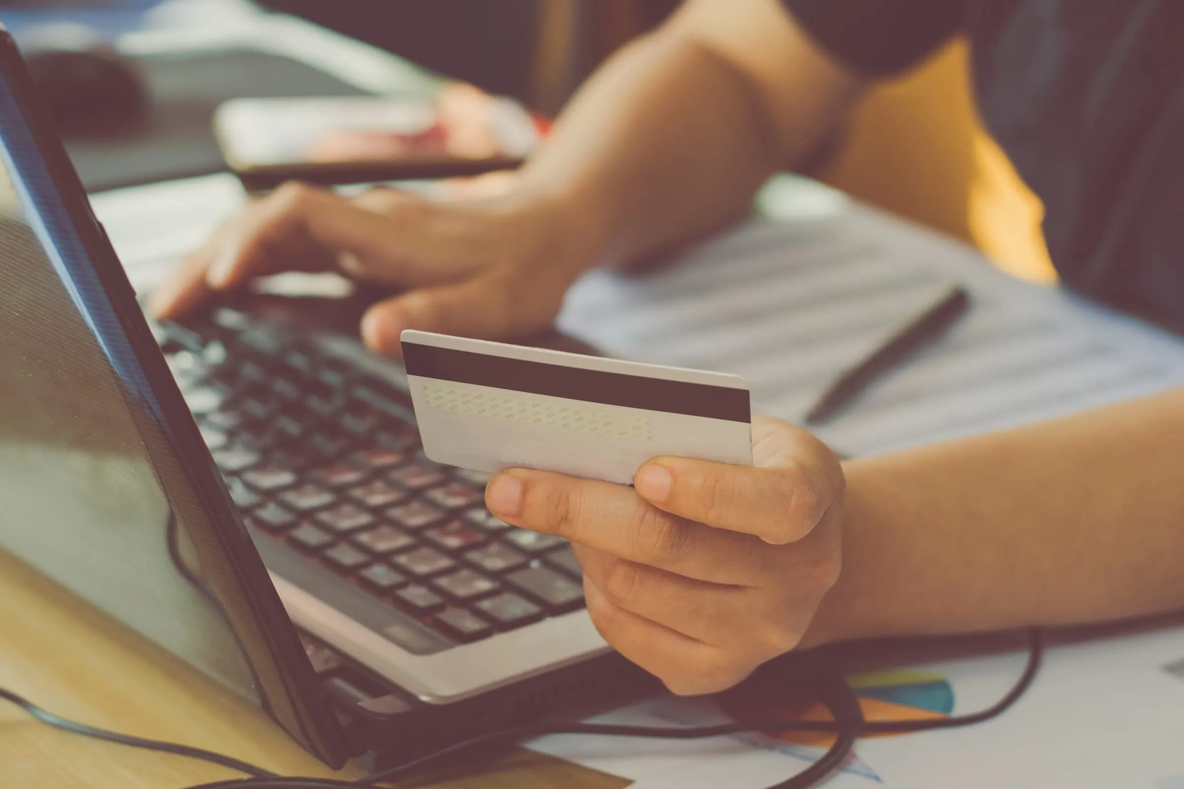 Customer paying online with a credit card at a laptop