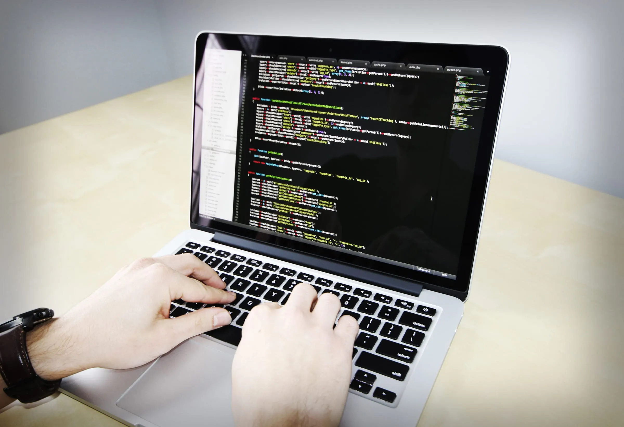 Developer typing code on a laptop
